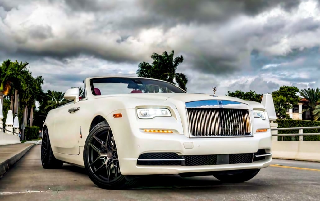 White Rolls-Royce Dawn beneath dramatic Miami clouds